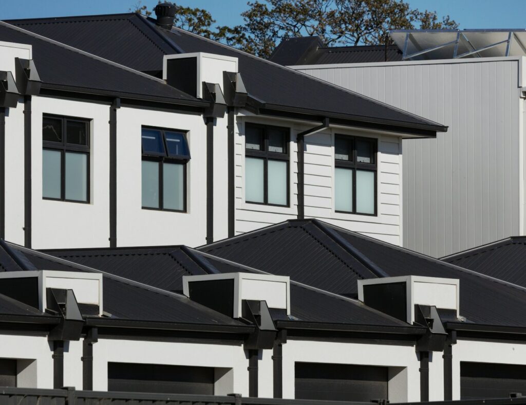 Newly completed modern Australian townhouses with dark rooflines and rendered facades