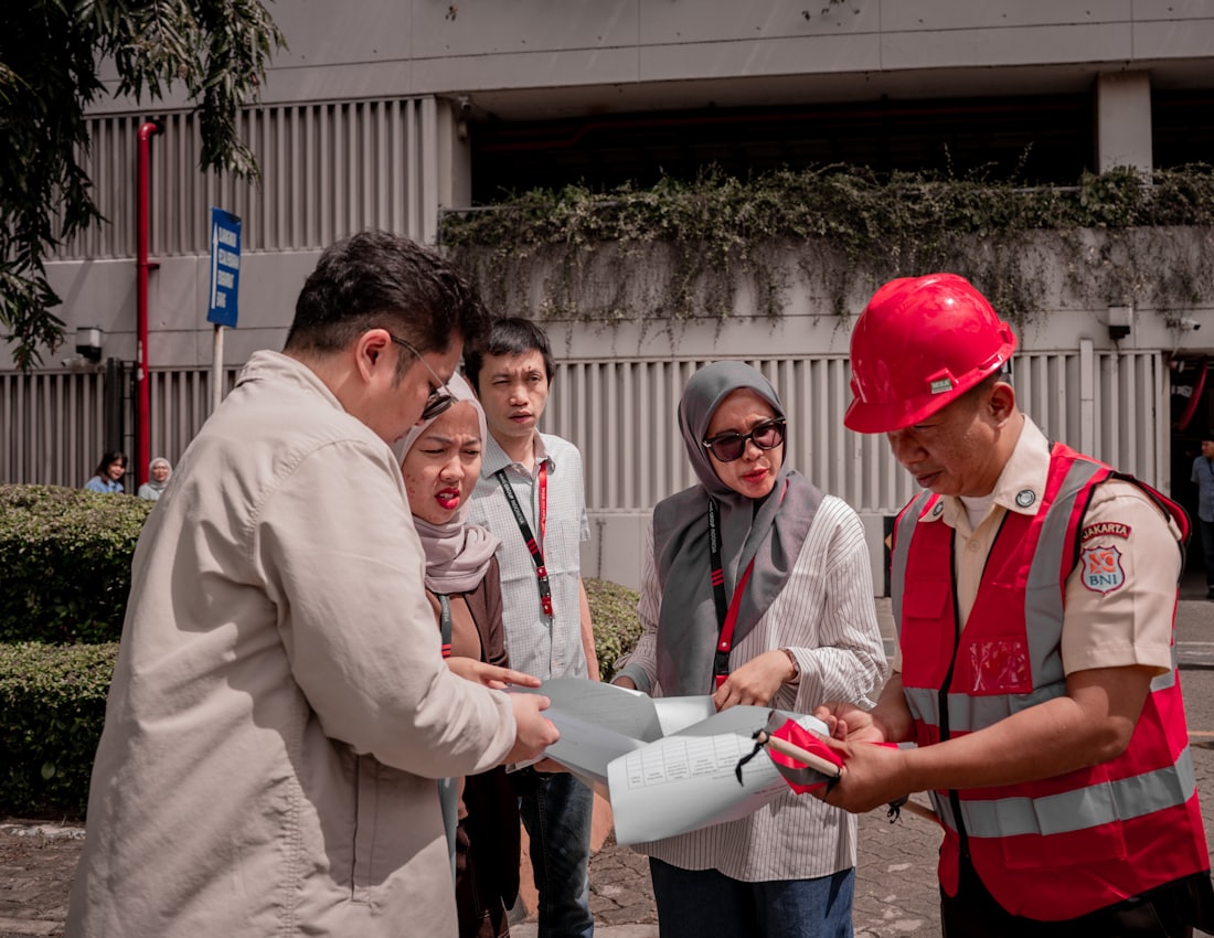 Construction project team reviewing building plans together on site