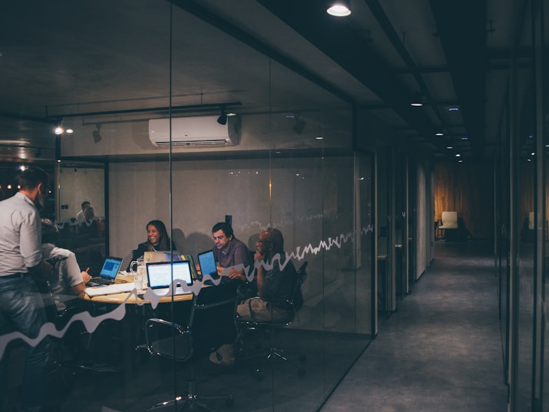 Finance team meeting in a glass-walled office boardroom